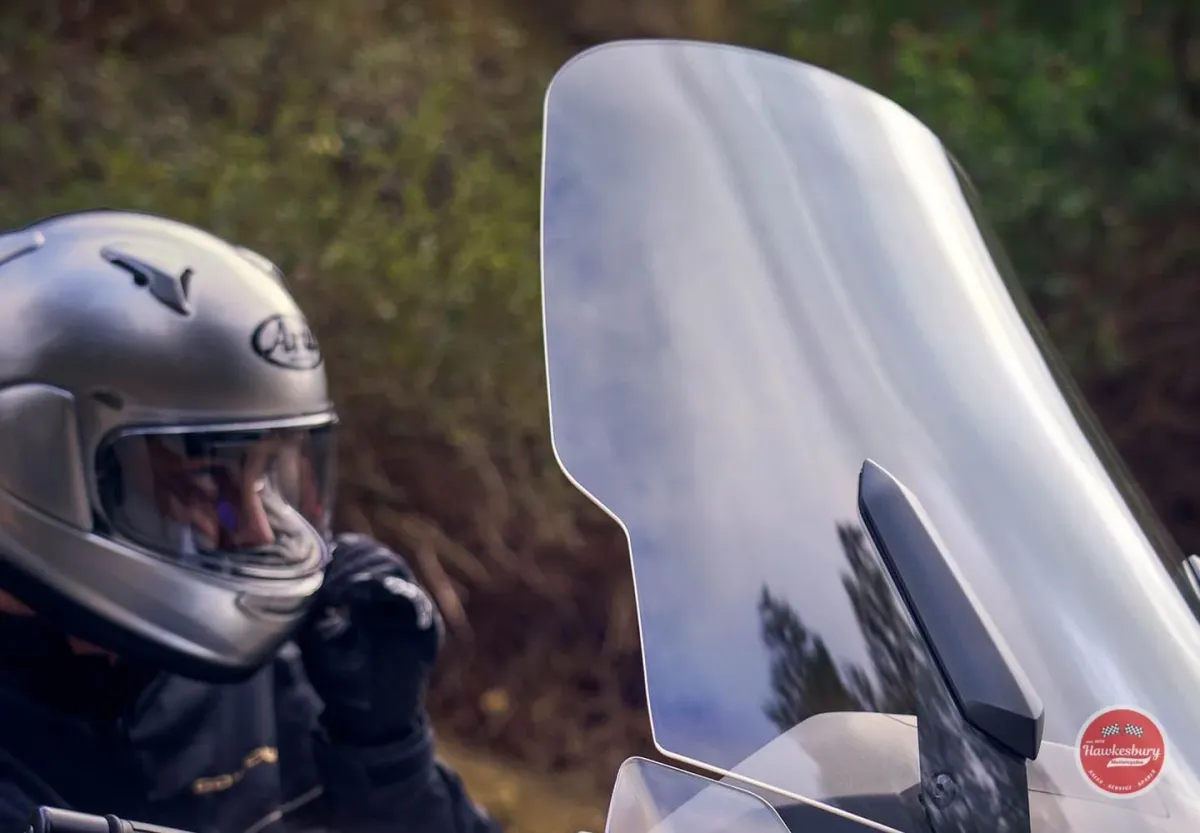 Rider in a silver helmet and black riding gear seated on a Honda Gold Wing behind its windscreen
