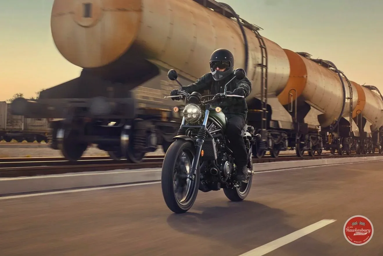 Honda CL500 scrambler with high-mounted twin exhaust and fork gaiters, side profile