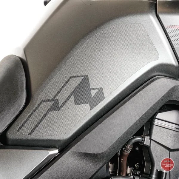 Motorcycle side panel with a stylised mountain-peak logo