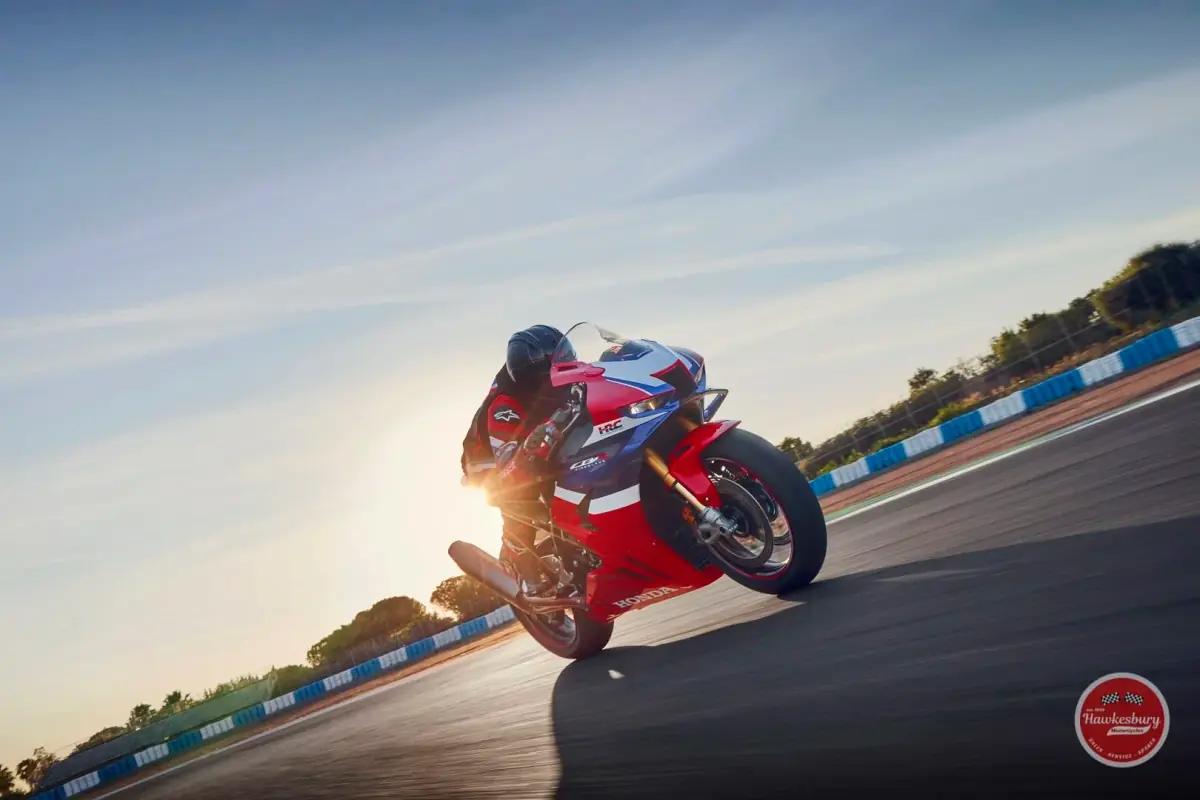 Honda CBR1000RR-R Fireblade SP in HRC red, white and blue livery cornering hard on a race circuit