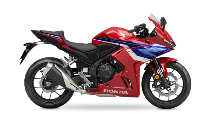Honda CBR500R supersport motorcycle in red, white and blue, studio side profile